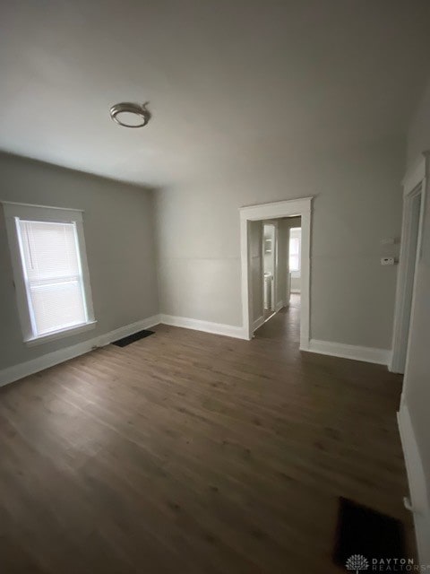 spare room featuring dark hardwood / wood-style flooring