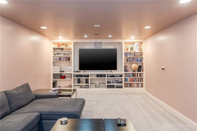 carpeted living room featuring built in shelves