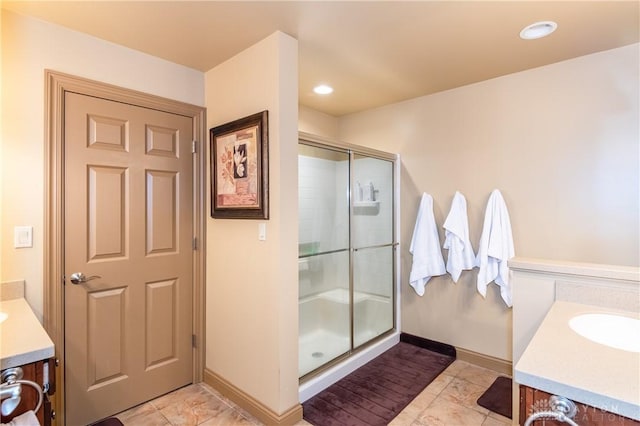 bathroom featuring tile patterned flooring, vanity, and a shower with shower door