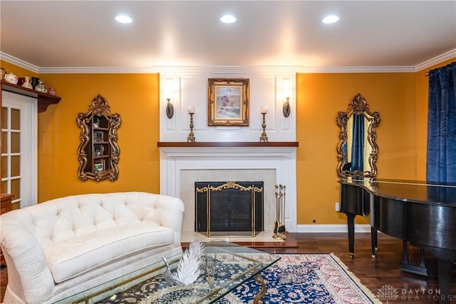 living area with dark hardwood / wood-style floors and ornamental molding