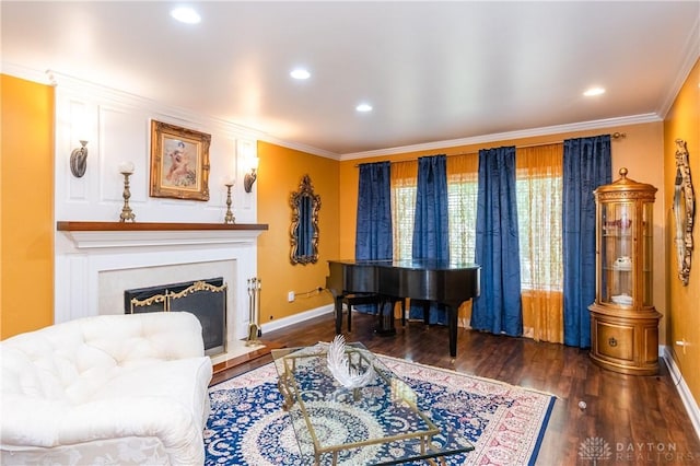 living area with dark hardwood / wood-style floors and ornamental molding