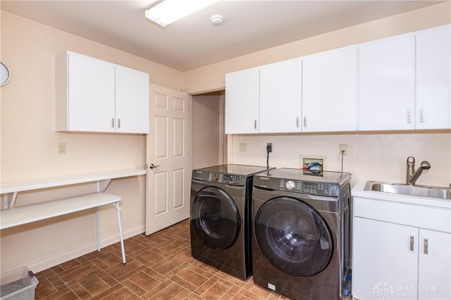 laundry room with sink, cabinets, and independent washer and dryer