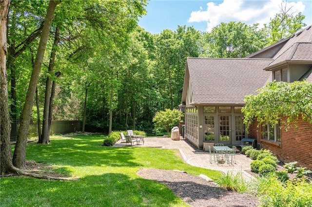 view of yard featuring french doors and a patio