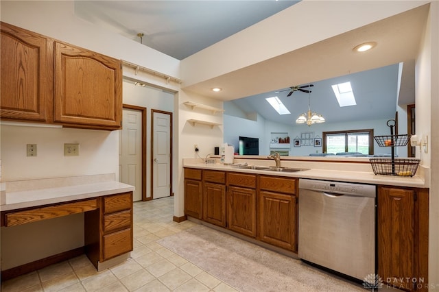 kitchen featuring vaulted ceiling with skylight, decorative light fixtures, dishwasher, sink, and a chandelier