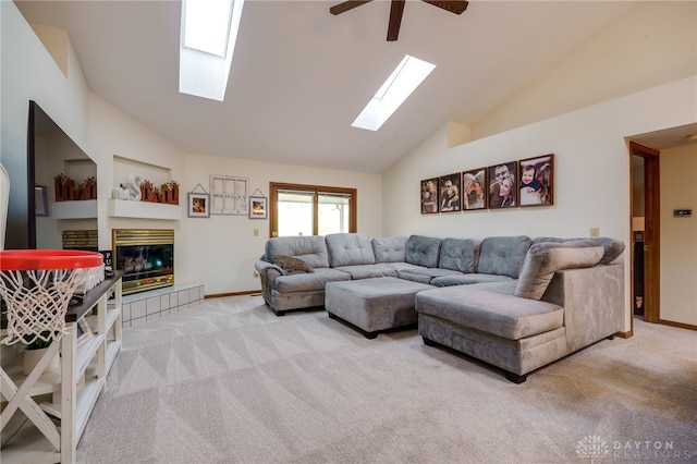 carpeted living room with a fireplace, high vaulted ceiling, and ceiling fan