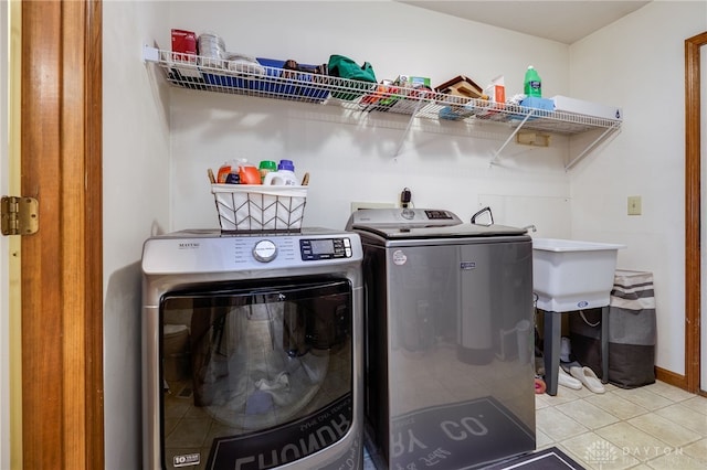 laundry area featuring light tile patterned floors and independent washer and dryer