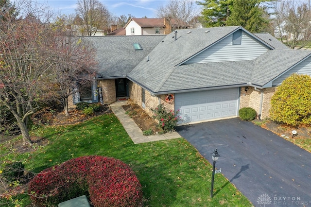 front of property featuring a garage and a front lawn