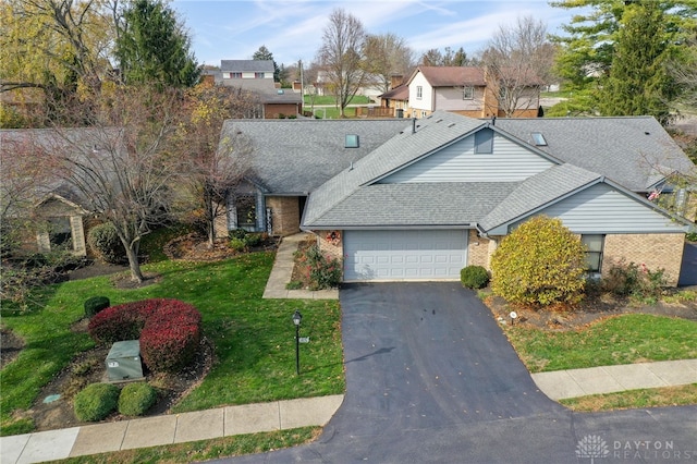 view of front facade with a garage and a front yard