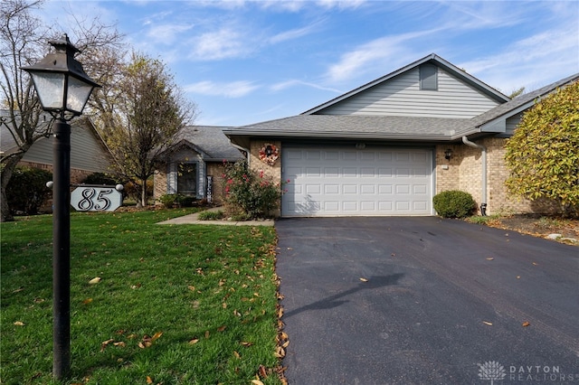 view of front of home with a garage and a front lawn