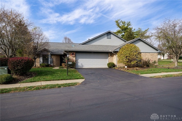 view of front of home with a front lawn and a garage