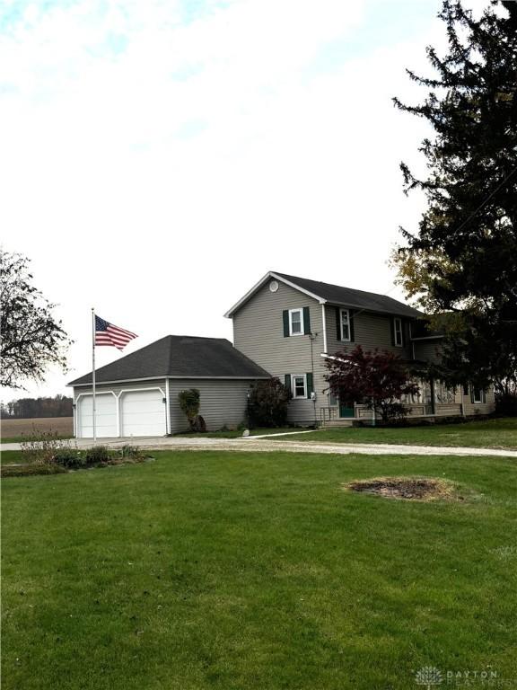 view of side of home with a yard and a garage