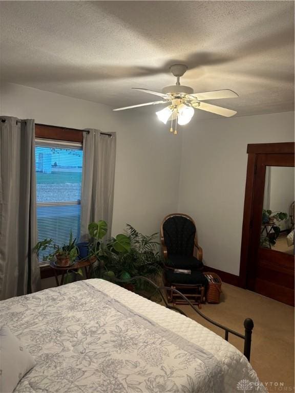 unfurnished bedroom featuring ceiling fan and a textured ceiling