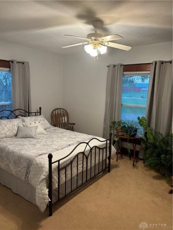 bedroom featuring ceiling fan and carpet floors