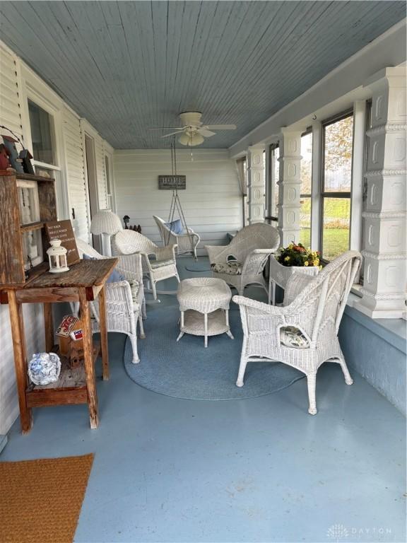 sunroom / solarium featuring ceiling fan