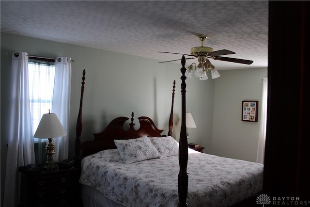 bedroom with a textured ceiling and ceiling fan