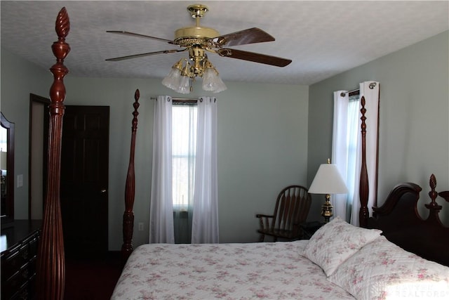 bedroom with ceiling fan and a textured ceiling