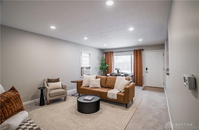 living room featuring cooling unit and light colored carpet