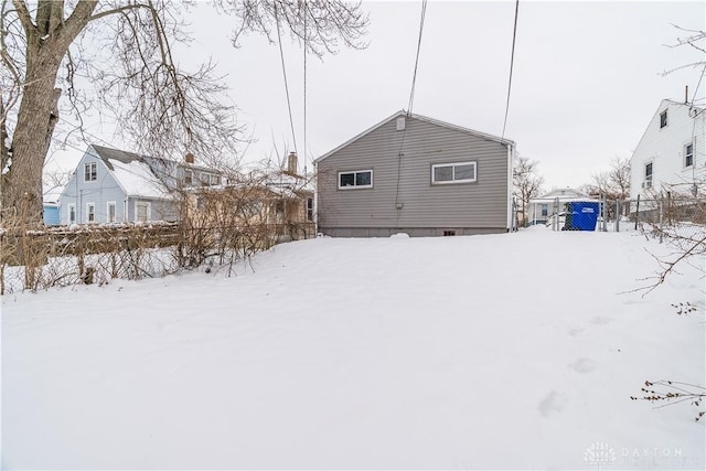 view of snow covered rear of property