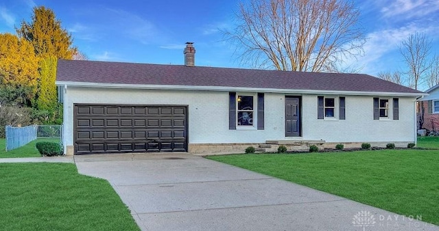 ranch-style house featuring a front yard and a garage