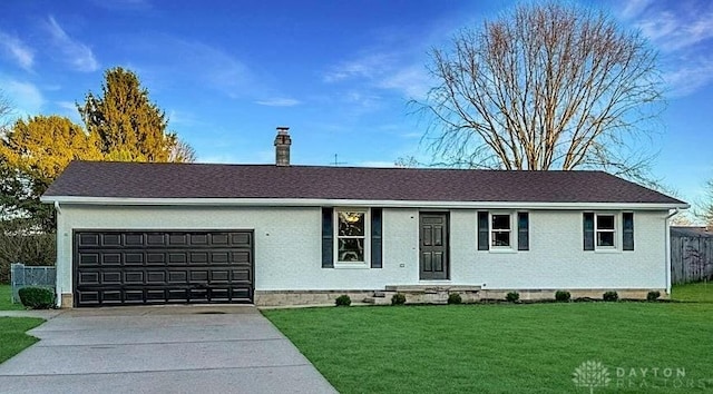 ranch-style home with a front yard and a garage