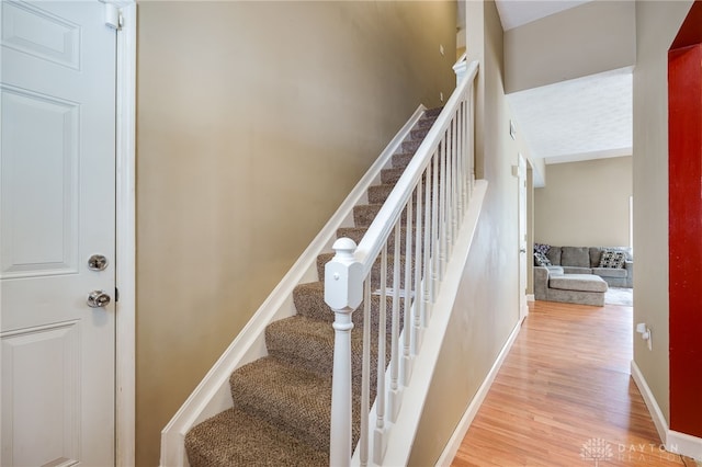 stairway featuring wood-type flooring