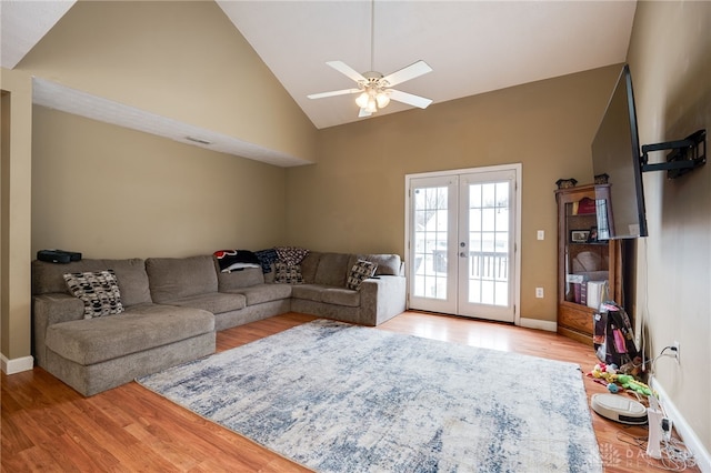 living room featuring french doors, light wood-type flooring, high vaulted ceiling, and ceiling fan