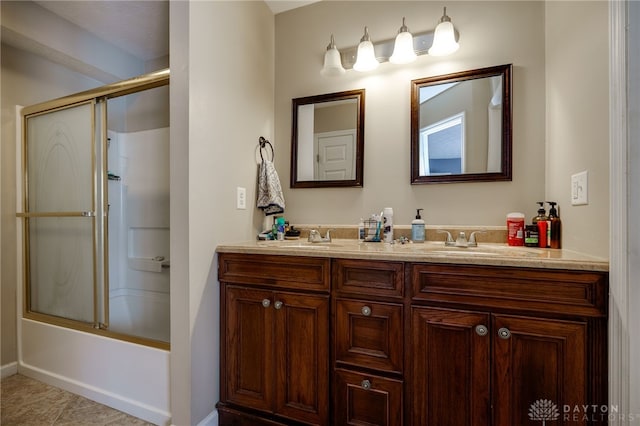 bathroom with shower / bath combination with glass door, vanity, and tile patterned flooring