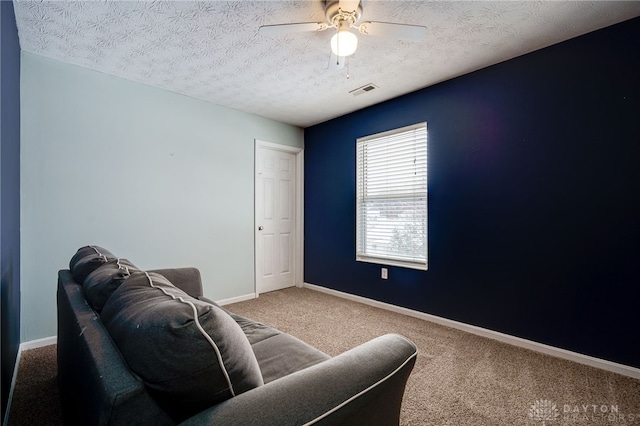 interior space featuring a textured ceiling and ceiling fan