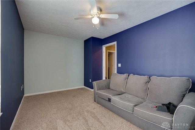 living room with carpet flooring, ceiling fan, and a textured ceiling