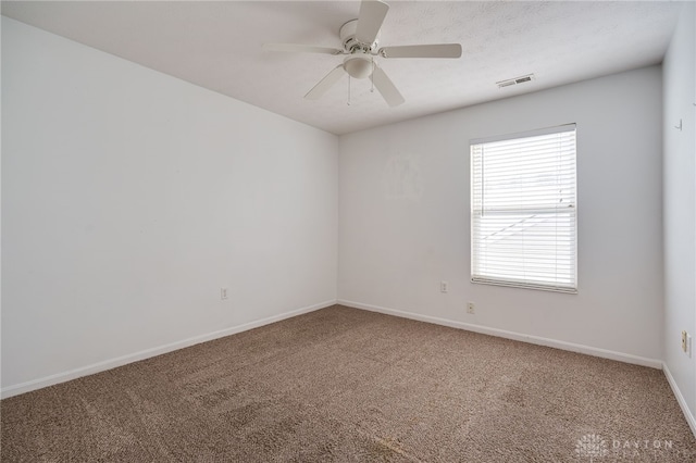 empty room with ceiling fan and carpet