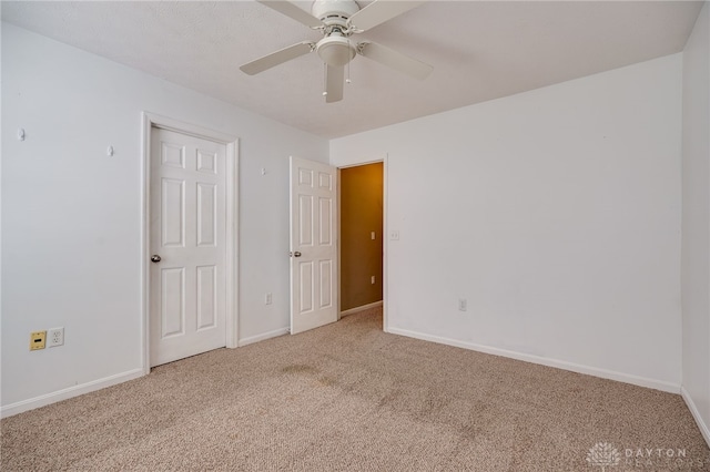 unfurnished room featuring carpet floors and ceiling fan