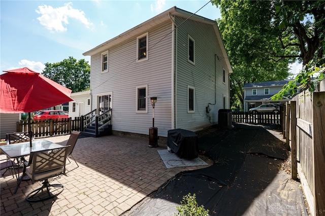 back of property with a patio and central AC unit