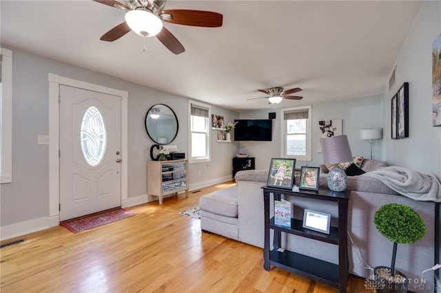 living room featuring ceiling fan and light wood-type flooring