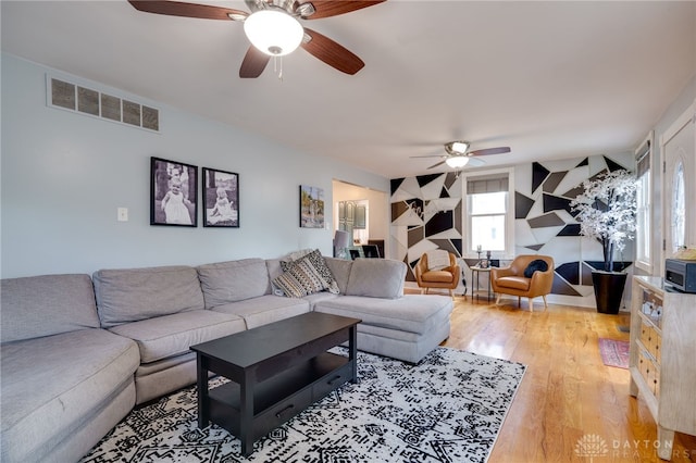 living room featuring ceiling fan and light hardwood / wood-style flooring