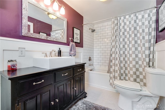 full bathroom with tile patterned flooring, vanity, toilet, and shower / bath combo with shower curtain