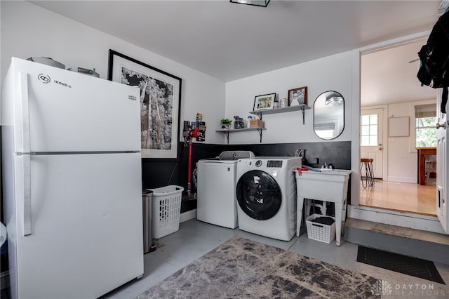 washroom with independent washer and dryer