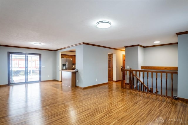 empty room with light hardwood / wood-style floors and ornamental molding