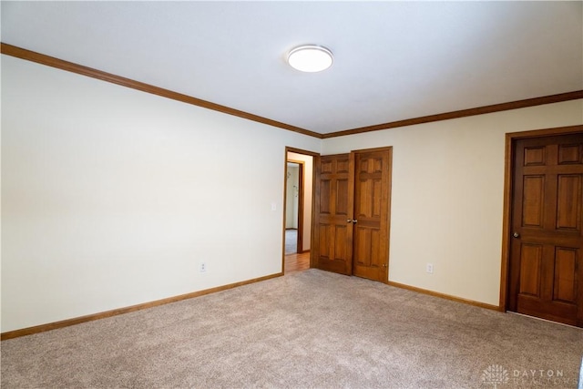 carpeted spare room with crown molding