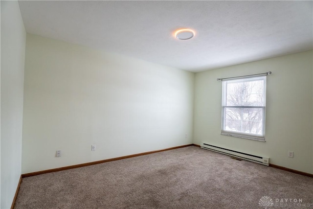 carpeted spare room with baseboard heating