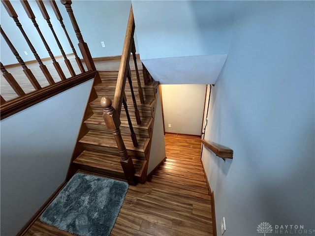 staircase with hardwood / wood-style floors