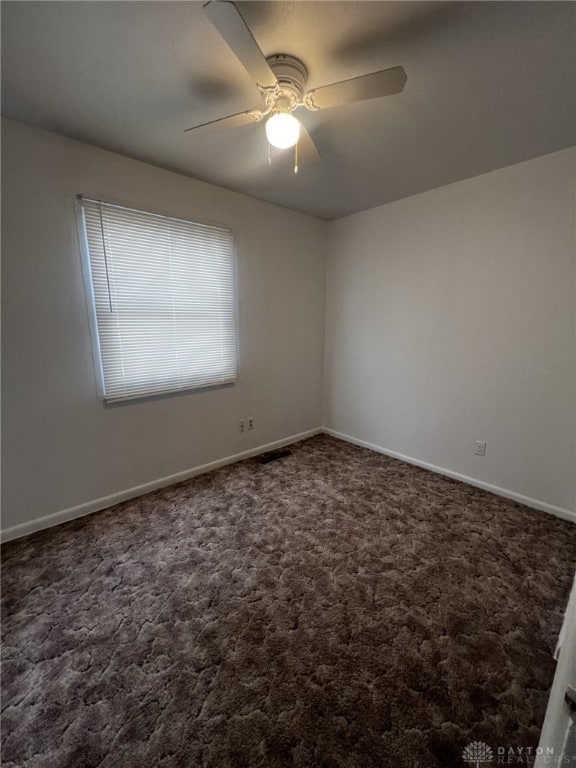 carpeted empty room with ceiling fan