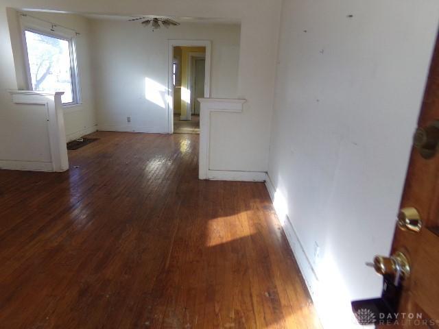 unfurnished room with dark hardwood / wood-style floors