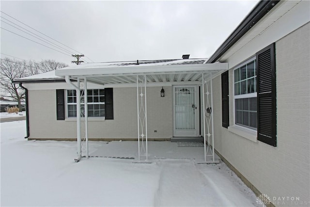 view of snow covered property entrance