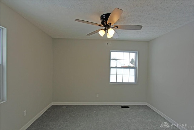 carpeted empty room featuring a textured ceiling and ceiling fan