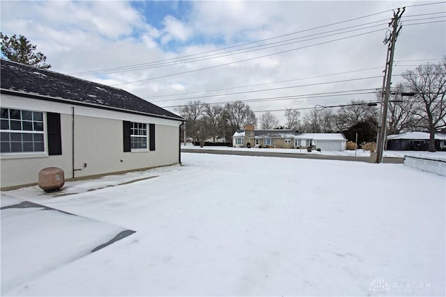 view of yard layered in snow