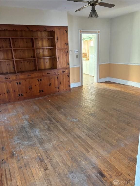 unfurnished living room with hardwood / wood-style flooring and ceiling fan