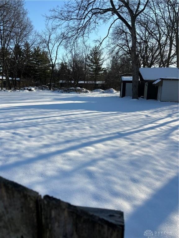 yard covered in snow with a garage