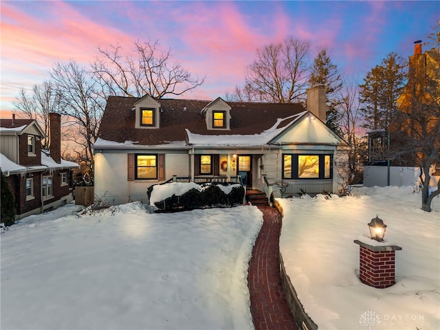 view of front of house featuring a porch and a fire pit