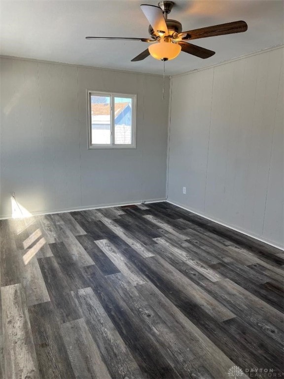 spare room with dark wood-type flooring