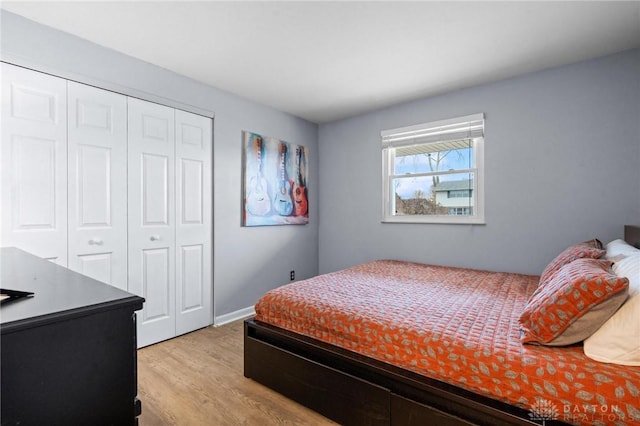 bedroom with light wood-type flooring and a closet